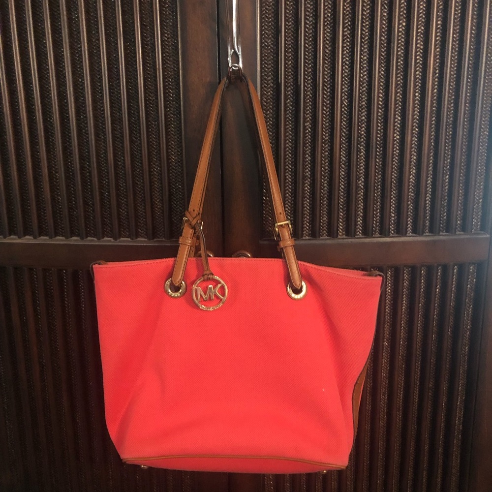 Micheal Kors large shoulder bag with leather straps, and footed bottom